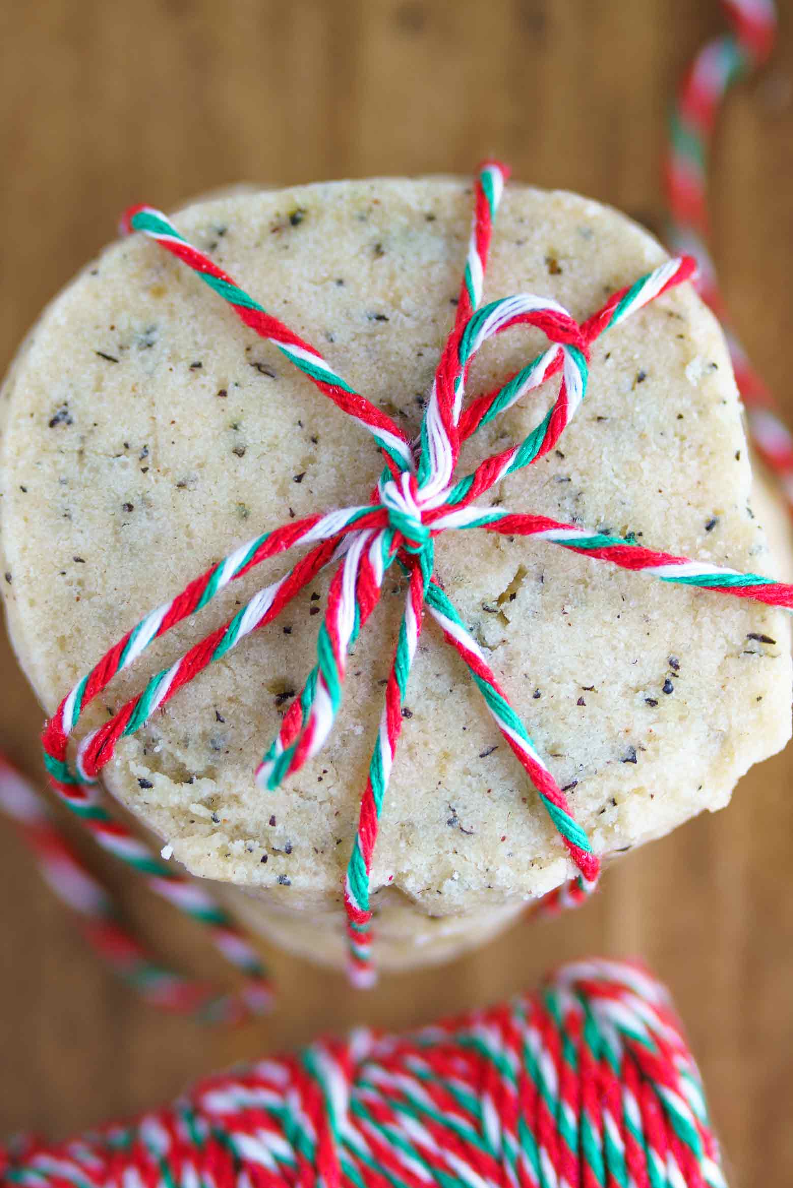 the top cookie on a stack of Christmas spice tea cookies tied with twine