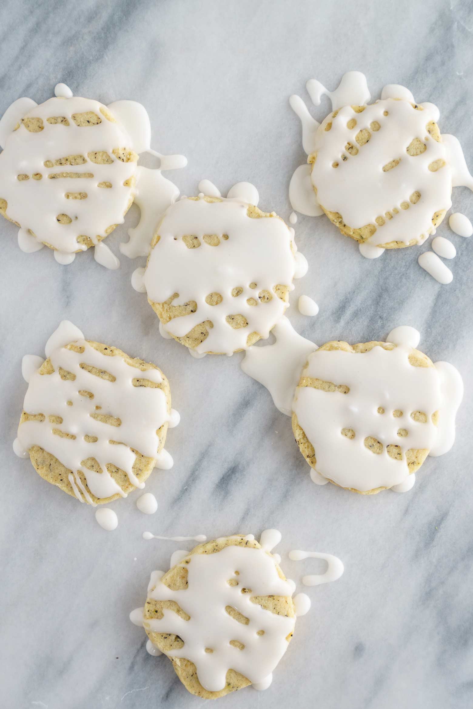 holiday spice tea cookies on marble with icing