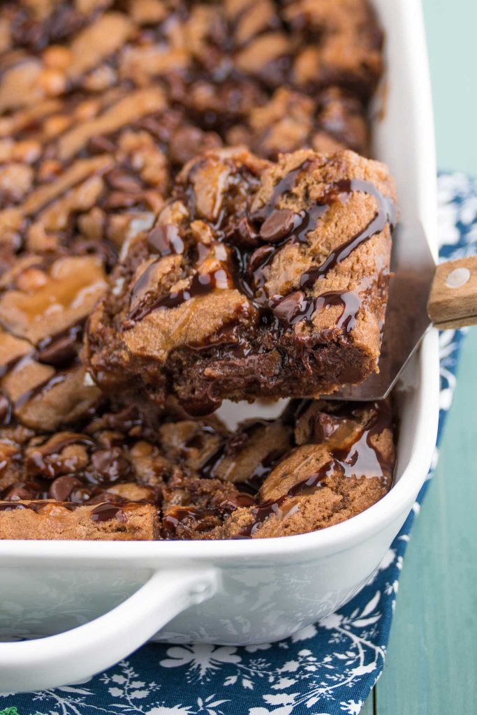 chocolate caramel cookie bar, soft and chewy brownie texture on a spatula