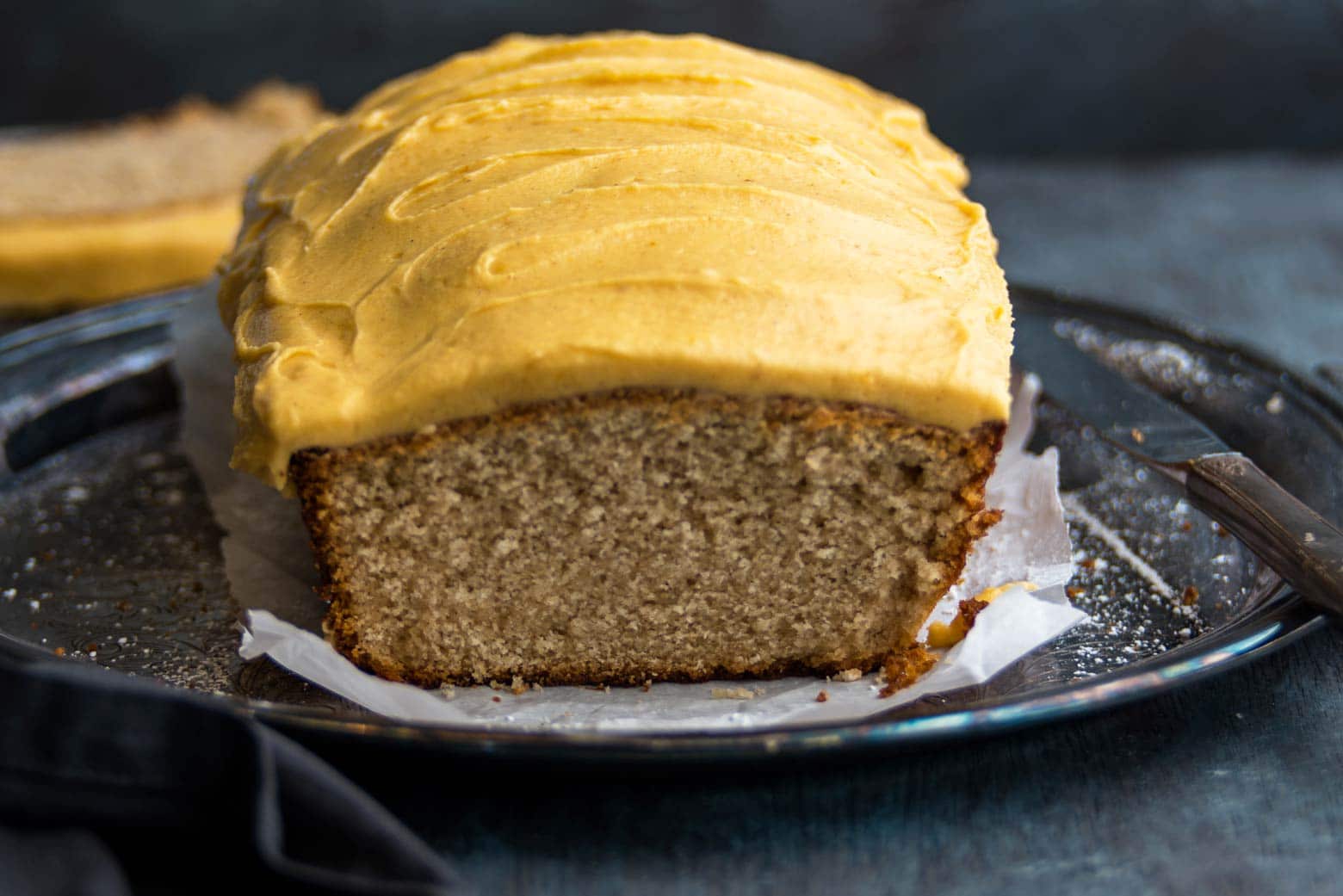 Pumpkin frosting iced autumn loaf cake on silver tray