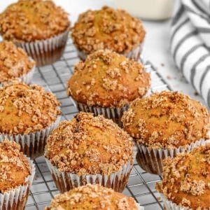 banana muffins with streusel topping resting on a cooling rack