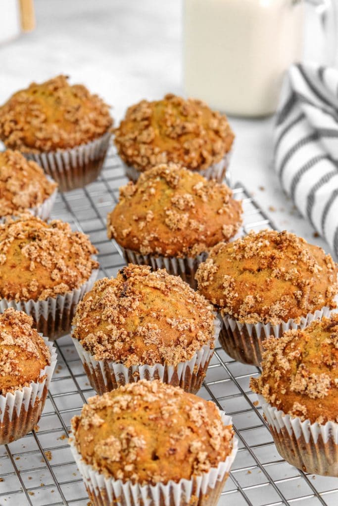 banana muffins with streusel topping resting on a cooling rack