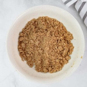 Basic streusel topping for a muffin in a white bowl on marble