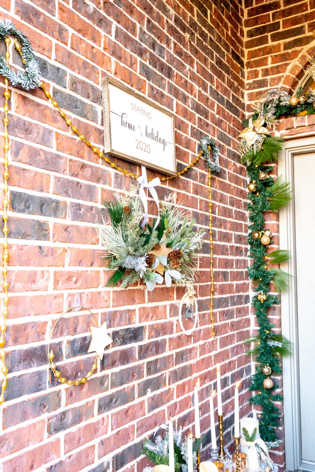 a wall of wreaths and a home for the holidays sign