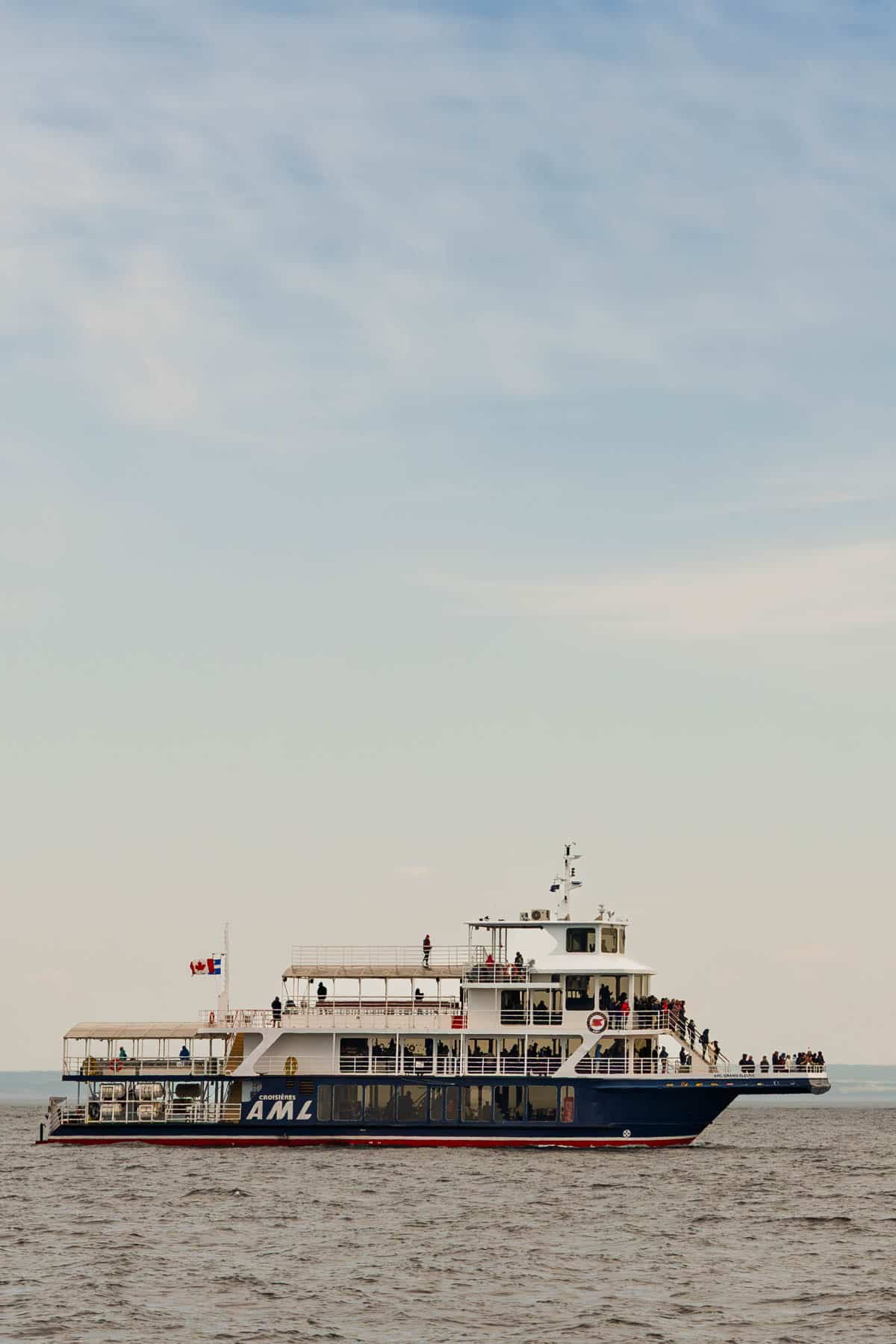 a whale watching cruiser boat floating in the water of the St Lawrence River