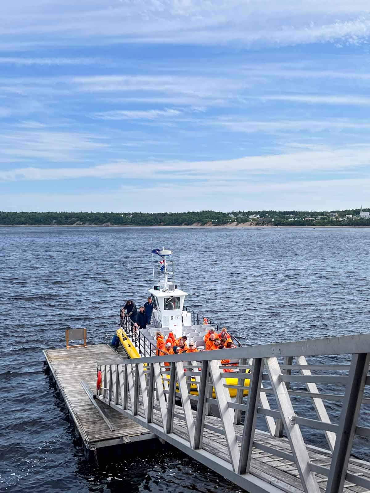 a yellow and white zodiac boat at the dock about to take tour members out to the marine park