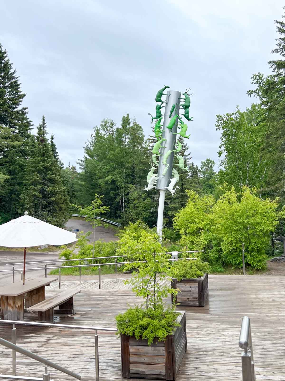 Outside dining at Zoo Sauvage de St Felicien with a decorative elk art installation.